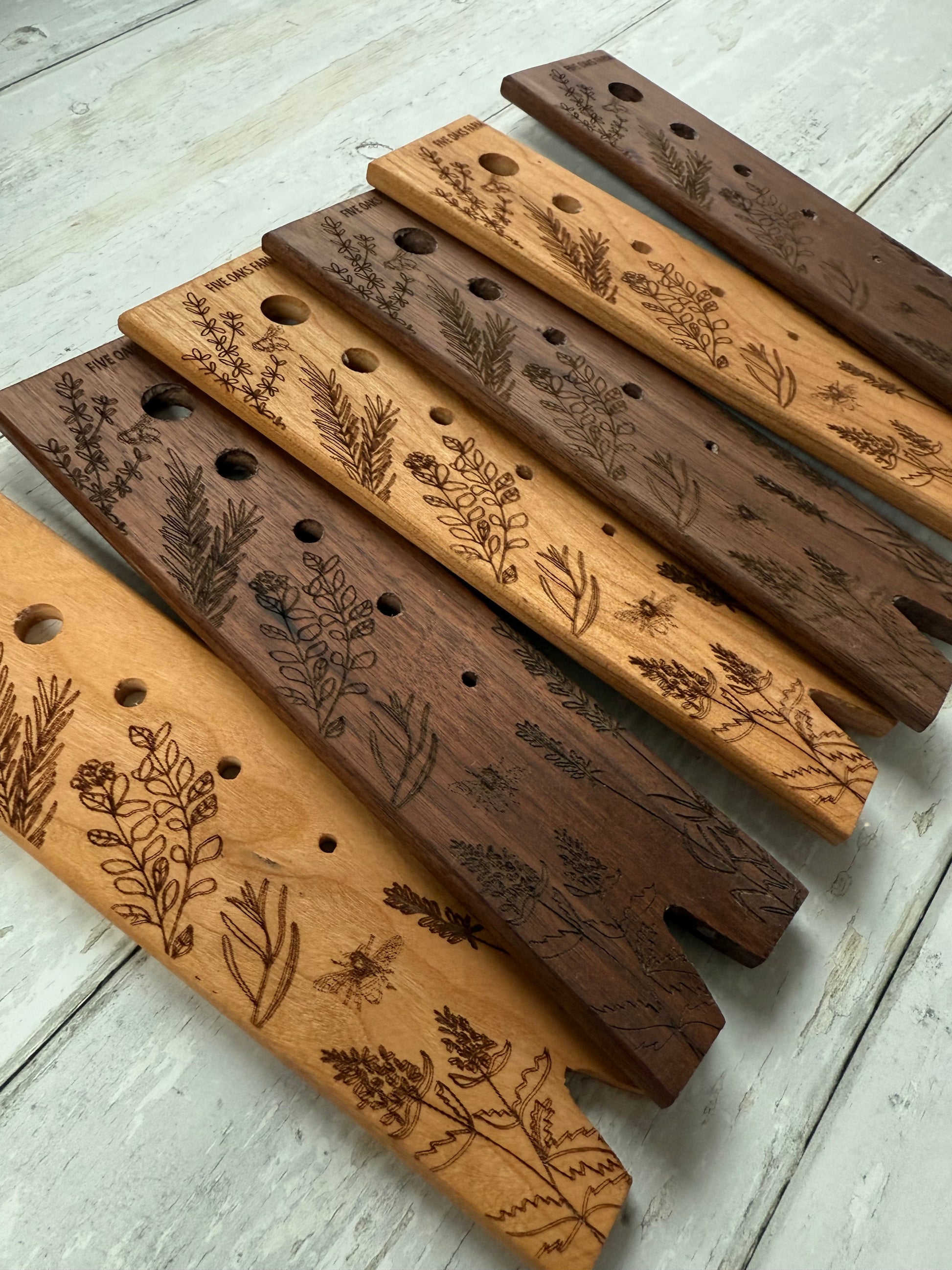 Herb stripper by Five Oaks Farm with metal prongs and wooden handle for easy herb removal and harvesting.