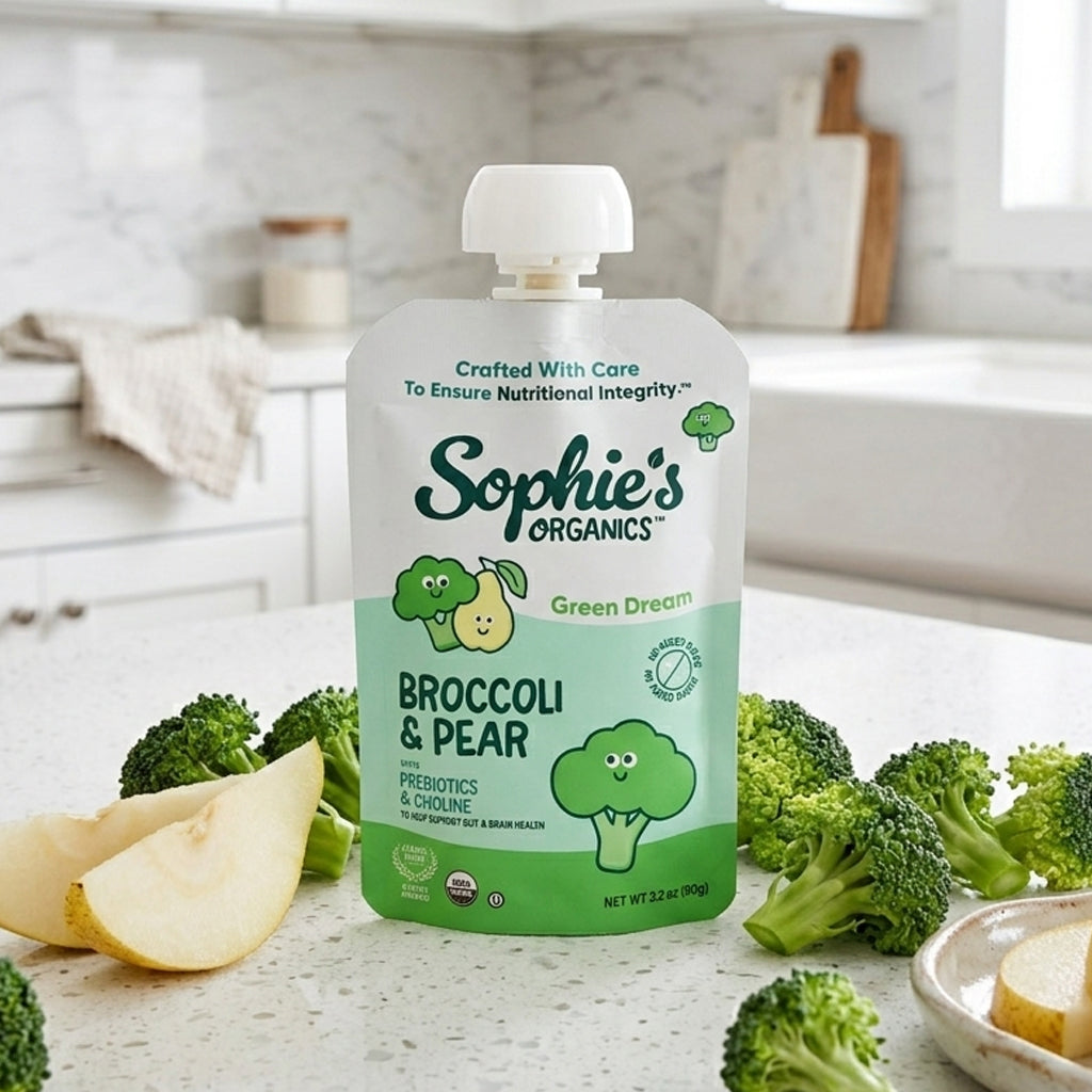 Baby snack pack featuring six green-colored snacks from Sophie's Organics Green Dream, displayed in a natural, lifestyle setting.