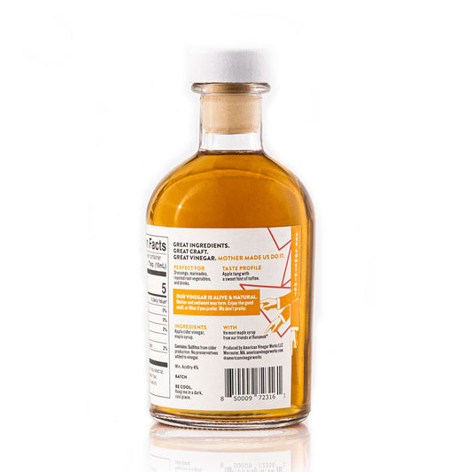 Back view of American Vinegar Works Maple Cider Vinegar bottle showing the label and clear glass container.