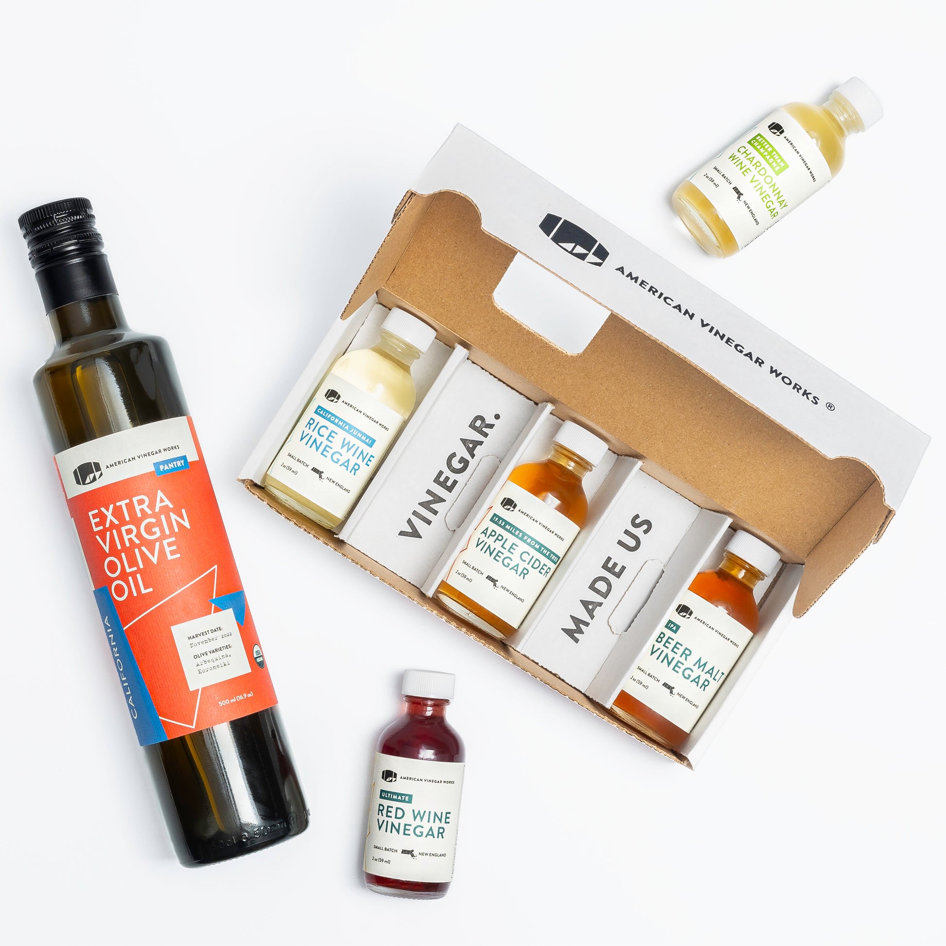 Mini American Vinegar Works oil and vinegar sampler bottle set with various vinegar flavors in small glass bottles.