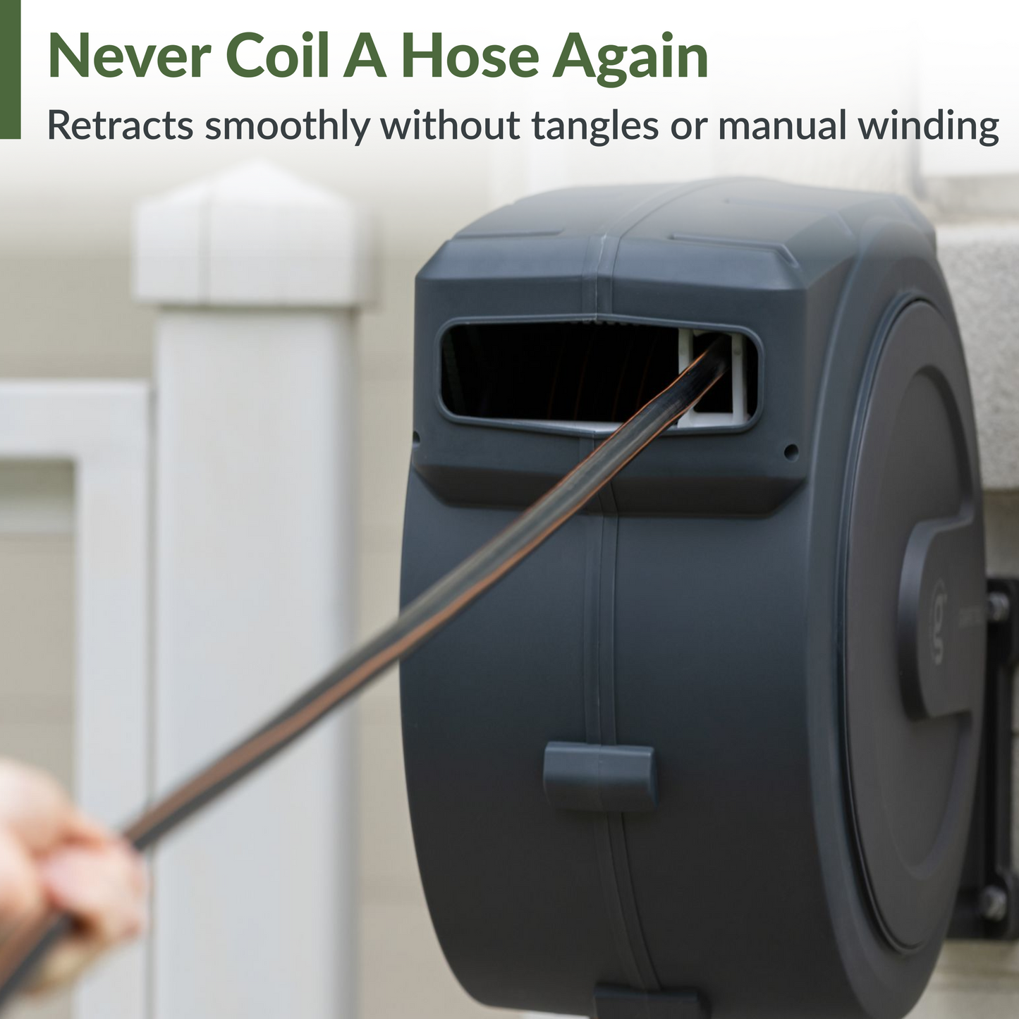 Giraffe Tools US retractable garden hose reel with 62ft to 155ft hose, mounted on a garden wall, black and silver design