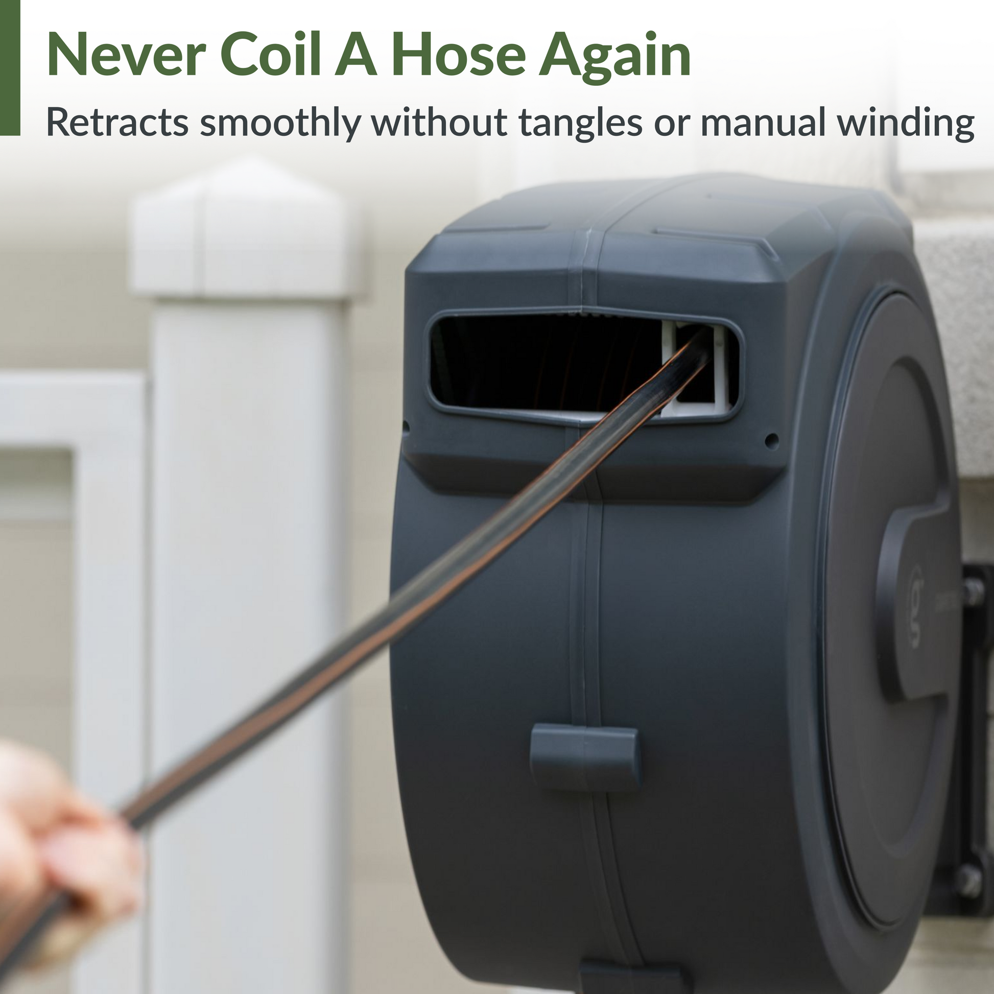 Giraffe Tools US retractable garden hose reel with 62ft to 155ft hose, mounted on a garden wall, black and silver design