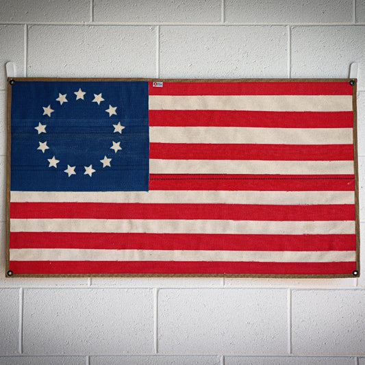 American flag made from recycled fire hose with Betsy Ross design by Recycled Firefighter, displayed on a white background.