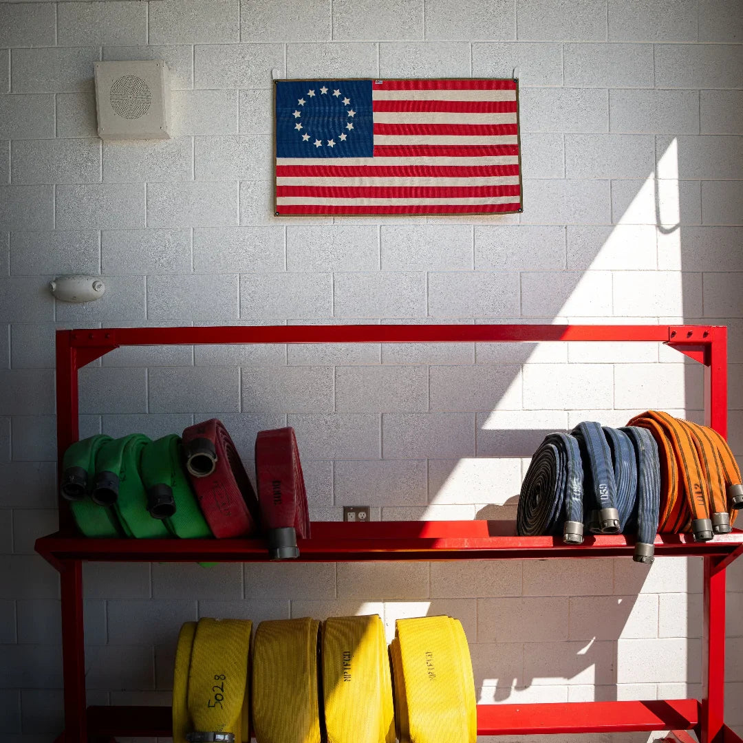 American flag made from recycled fire hose featuring Betsy Ross design, on a white background by Recycled Firefighter.