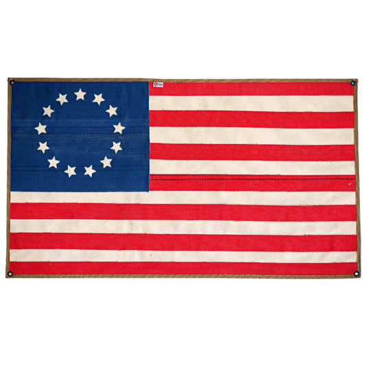 Recycled Firefighter Betsy Ross American flag made from fire hose, displayed on a white background.