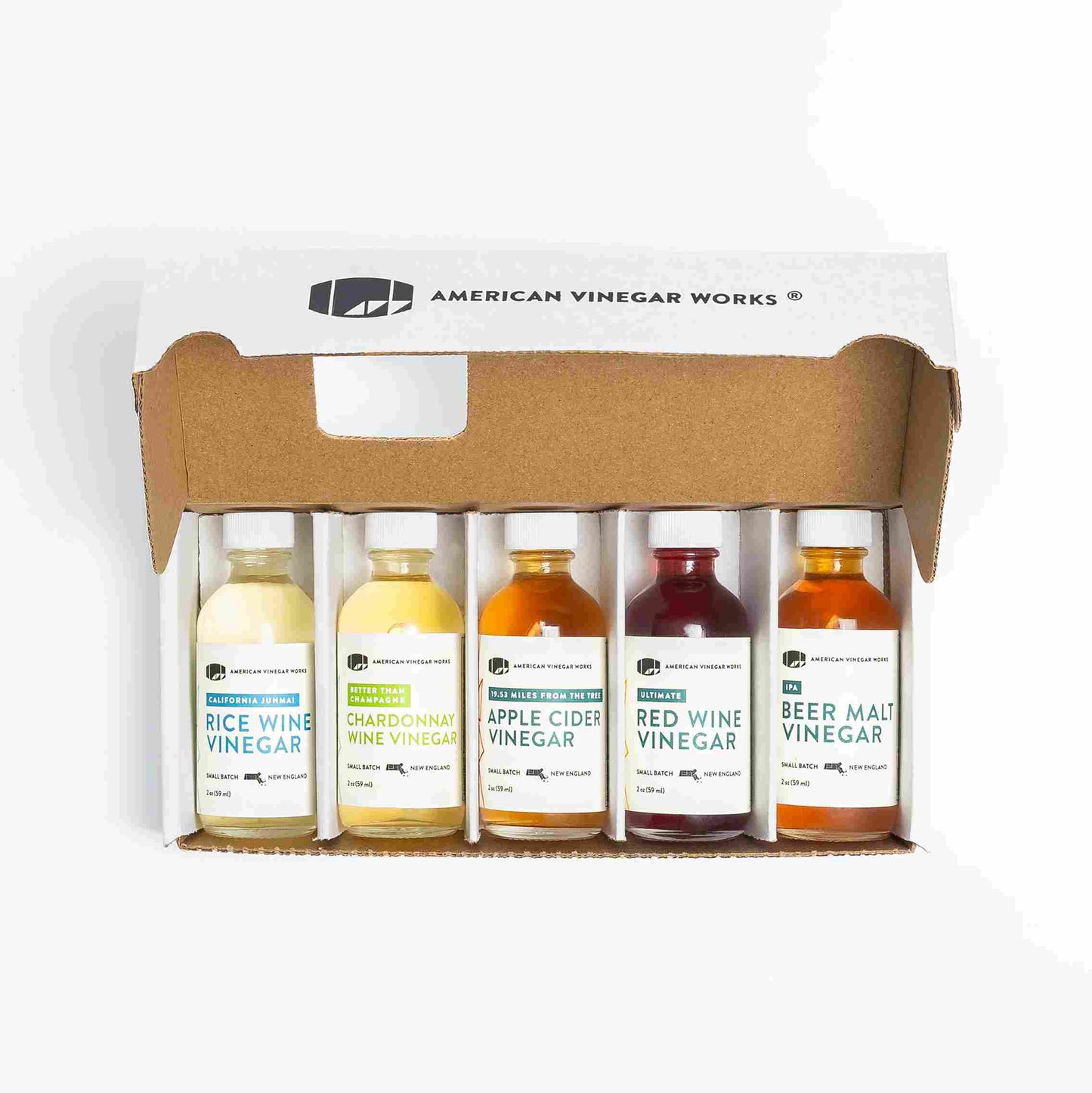 American Vinegar Works Essentials Plus Vinegar Sampler Pack with five barrel-aged vinegar bottles arranged in a display.