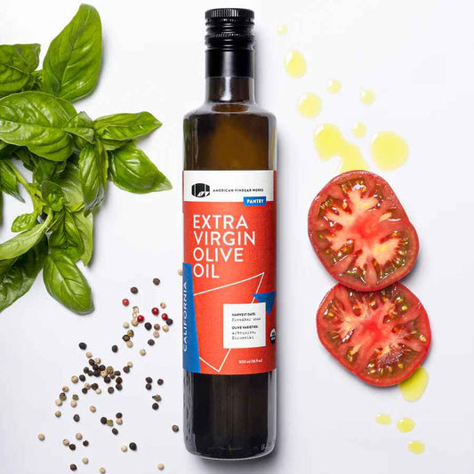 Bottle of American Vinegar Works California Organic Extra Virgin Olive Oil, with a clear label and dark glass bottle.
