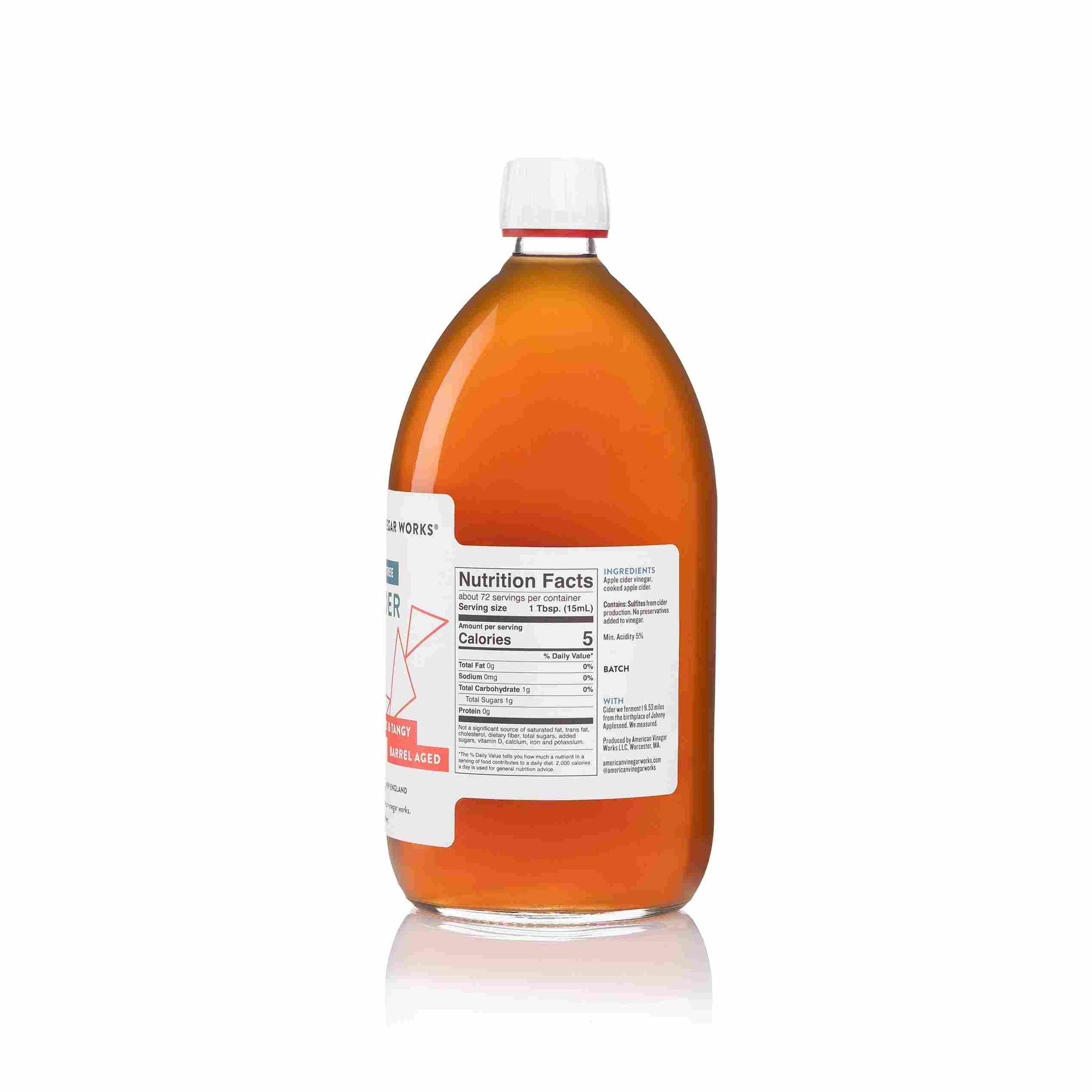 Front view of American Vinegar Works apple cider vinegar bottle labeled "19.53 Miles From The Tree" with amber liquid inside.