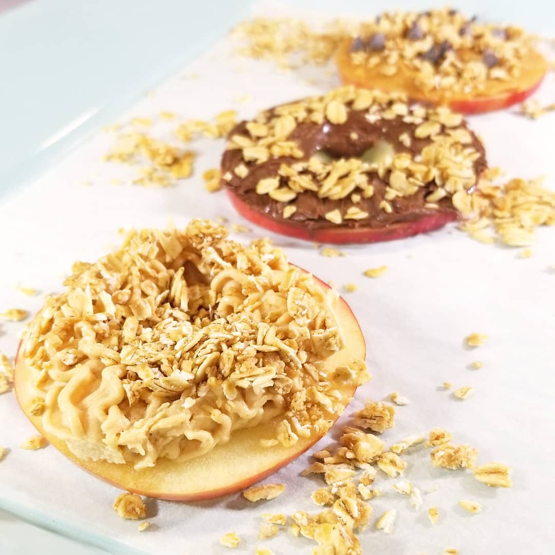 Two 12 oz packs of BuyNebraska.com Peanut Butter Granola with apple donut toppings, gluten, soy, and dairy free.