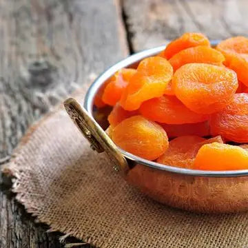Dried Turkish apricots from Onic Brands LLC showing vibrant orange, wrinkled surface, and chewy texture in a close-up image.