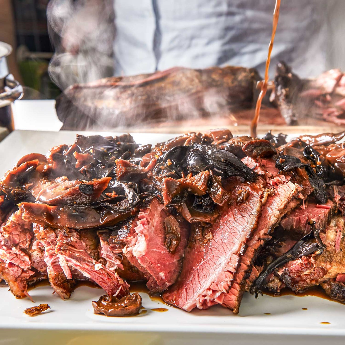 Award-winning brisket and ribs feast by Pig of the Month BBQ, featuring tender, smoked meats perfect for sharing.