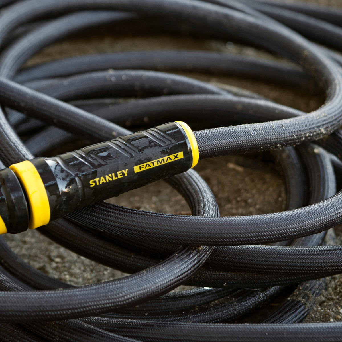 Orbit Irrigation Stanley 100 ft fabric garden hose with swivel coupling, flexible and durable for outdoor watering.