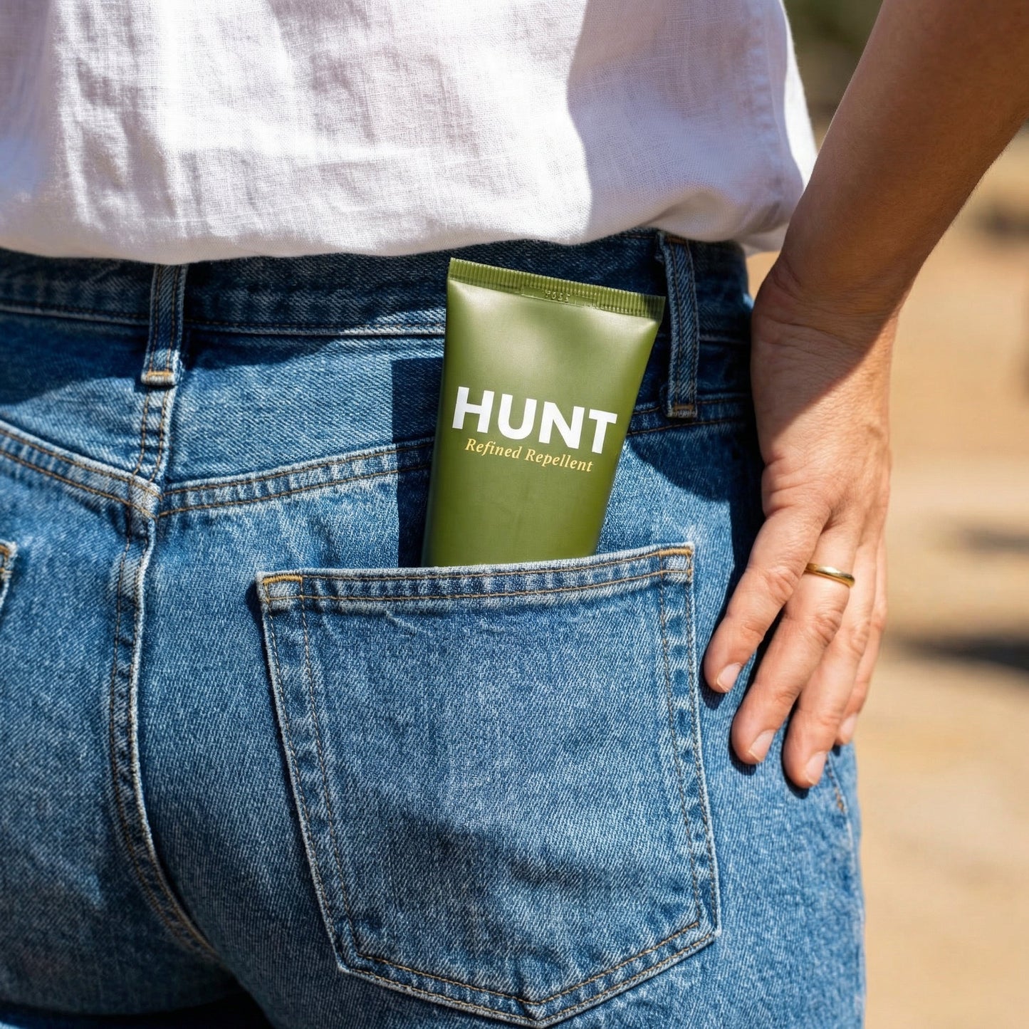 Hunt scent-free, DEET-free insect repellent lotion shown in a back pocket for outdoor protection.