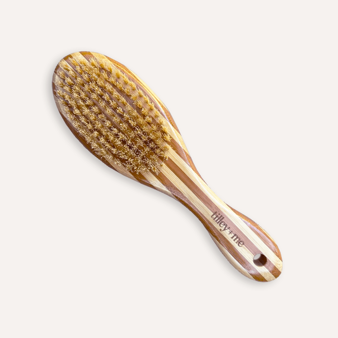 Two-sided Tilley + Me dog grooming brush with bristle and wire sides for shedding and detangling, featuring a bamboo handle.