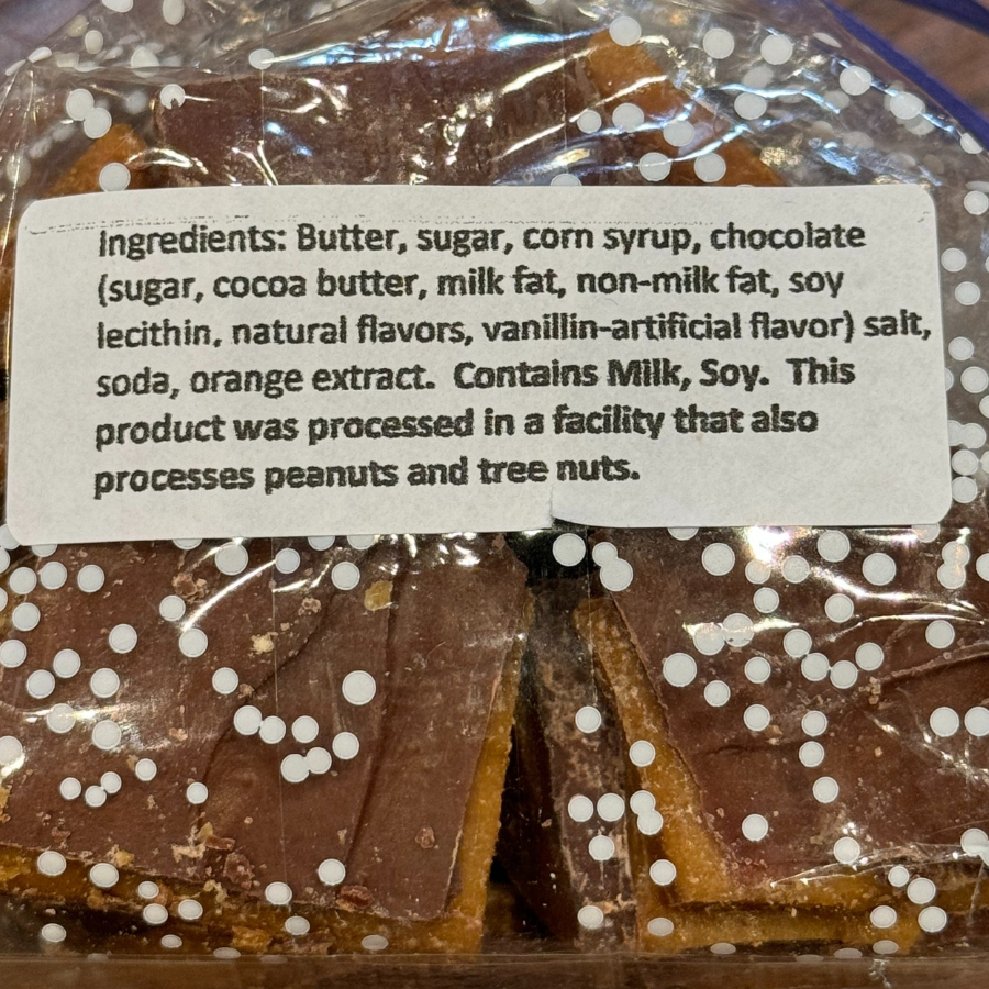 Homemade milk chocolate toffee by Barb's Buttery Toffee with assorted nuts, 8 oz, on a white background.