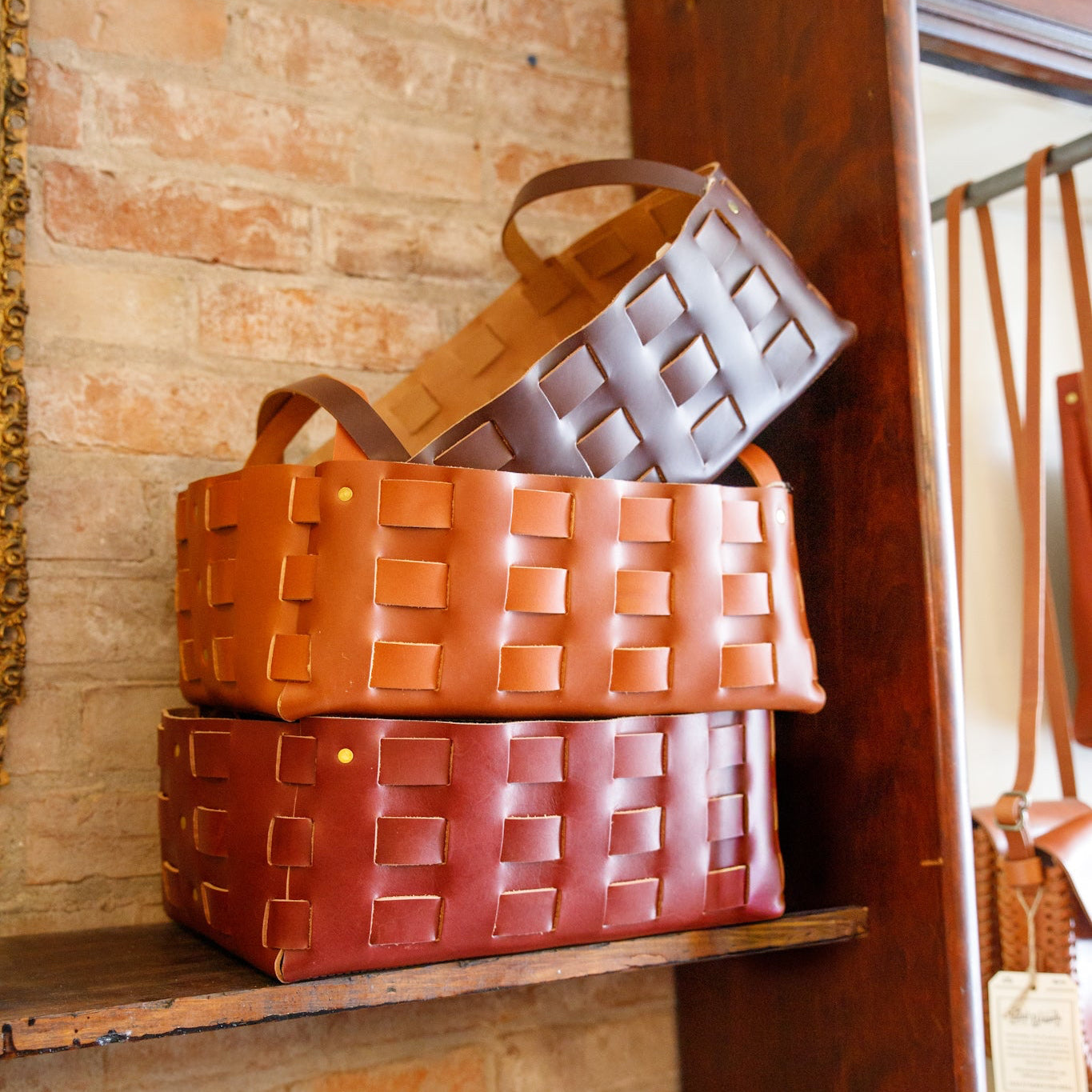 Large woven leather basket by The Local Branch, USA-made, featuring intricate leather weave and sturdy handles for versatile storage.