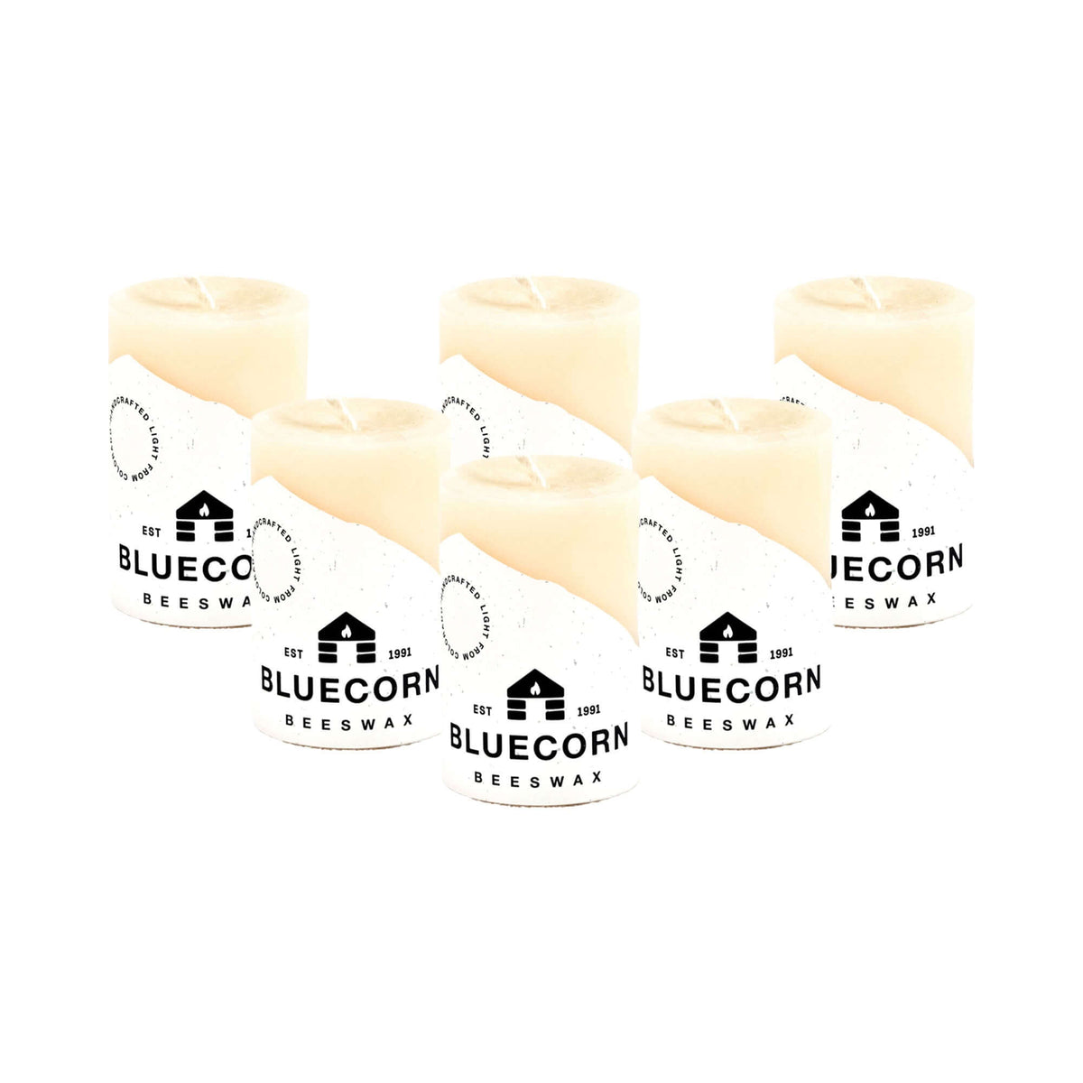 Six ivory pure beeswax pillar candles by Bluecorn Candles, small 2x3-inch size, arranged in a bulk pack with natural textured surface.