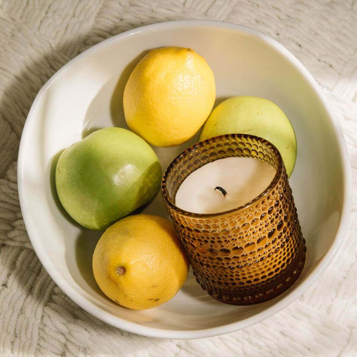 Bluecorn Candles Paloma Scented Candle in glassware, handmade and non-toxic, with warm fall tones and aromatic fragrance.