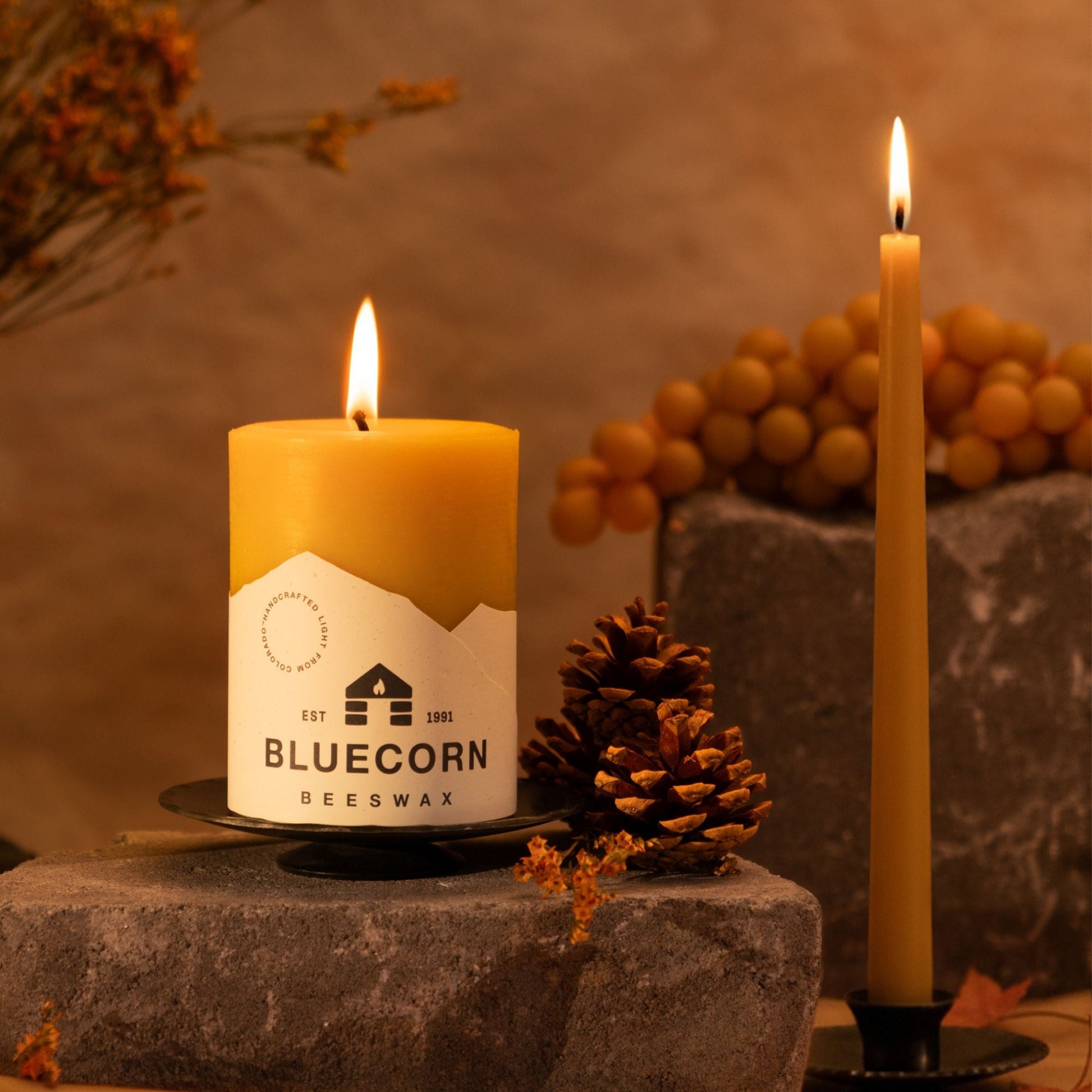 Pure beeswax pillar candles by Bluecorn Candles, featuring natural raw beeswax with matching taper candles for fall and winter decor.