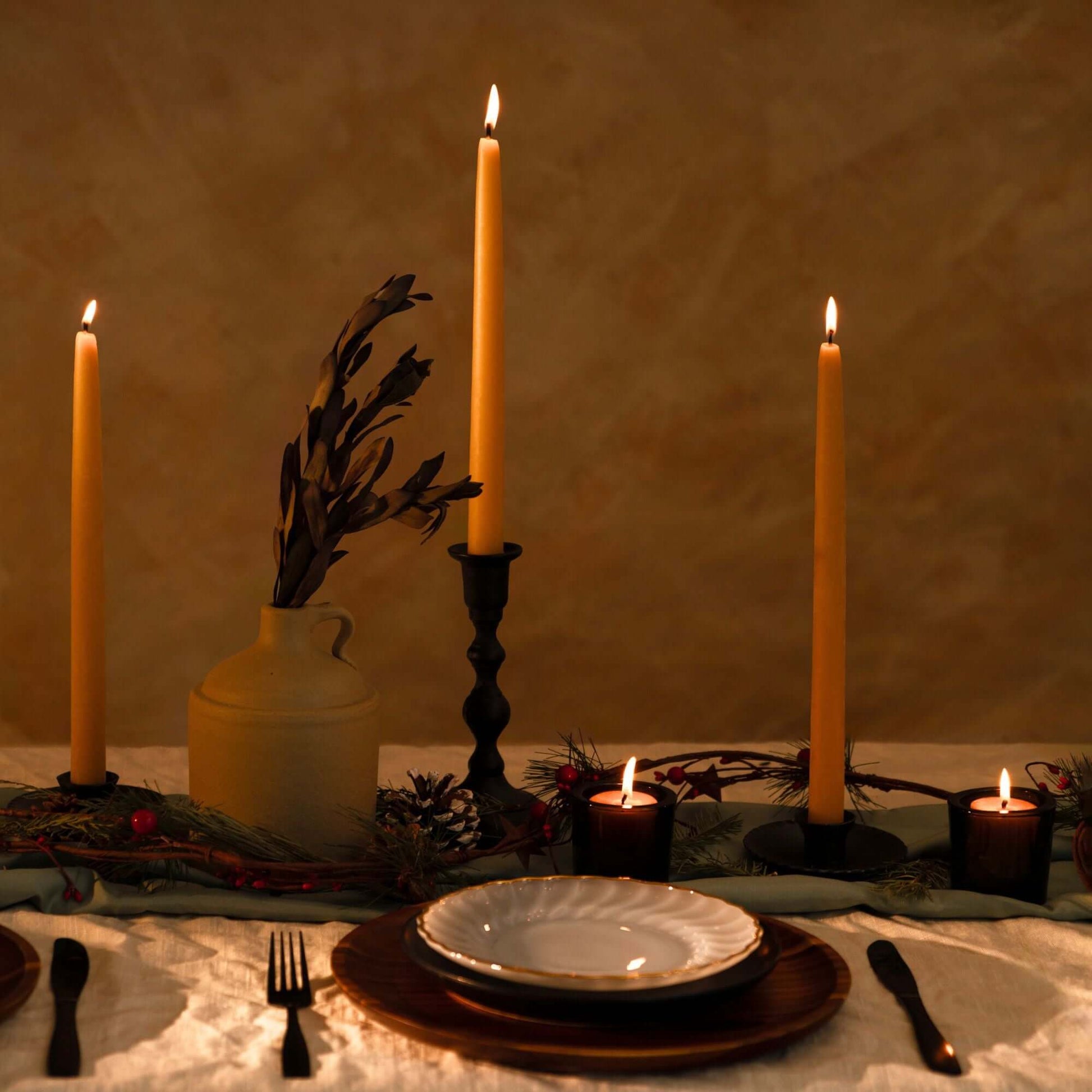 Pair of Bluecorn Candles hand-dipped beeswax taper candles and tea lights on a fall-themed table display.
