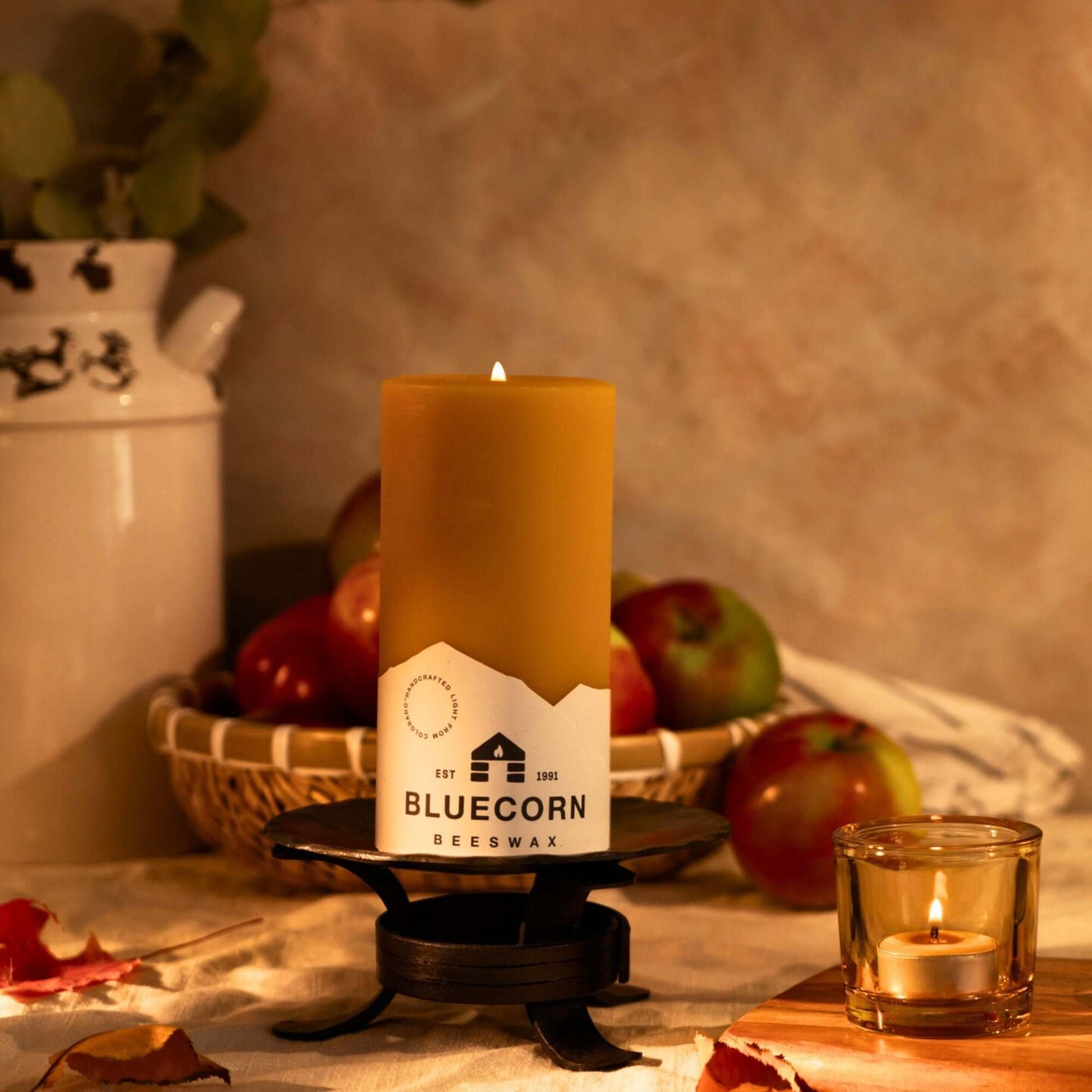 Bluecorn Candles pure beeswax pillar candle with tea light in glass holder, ideal for fall decor and warm lighting.