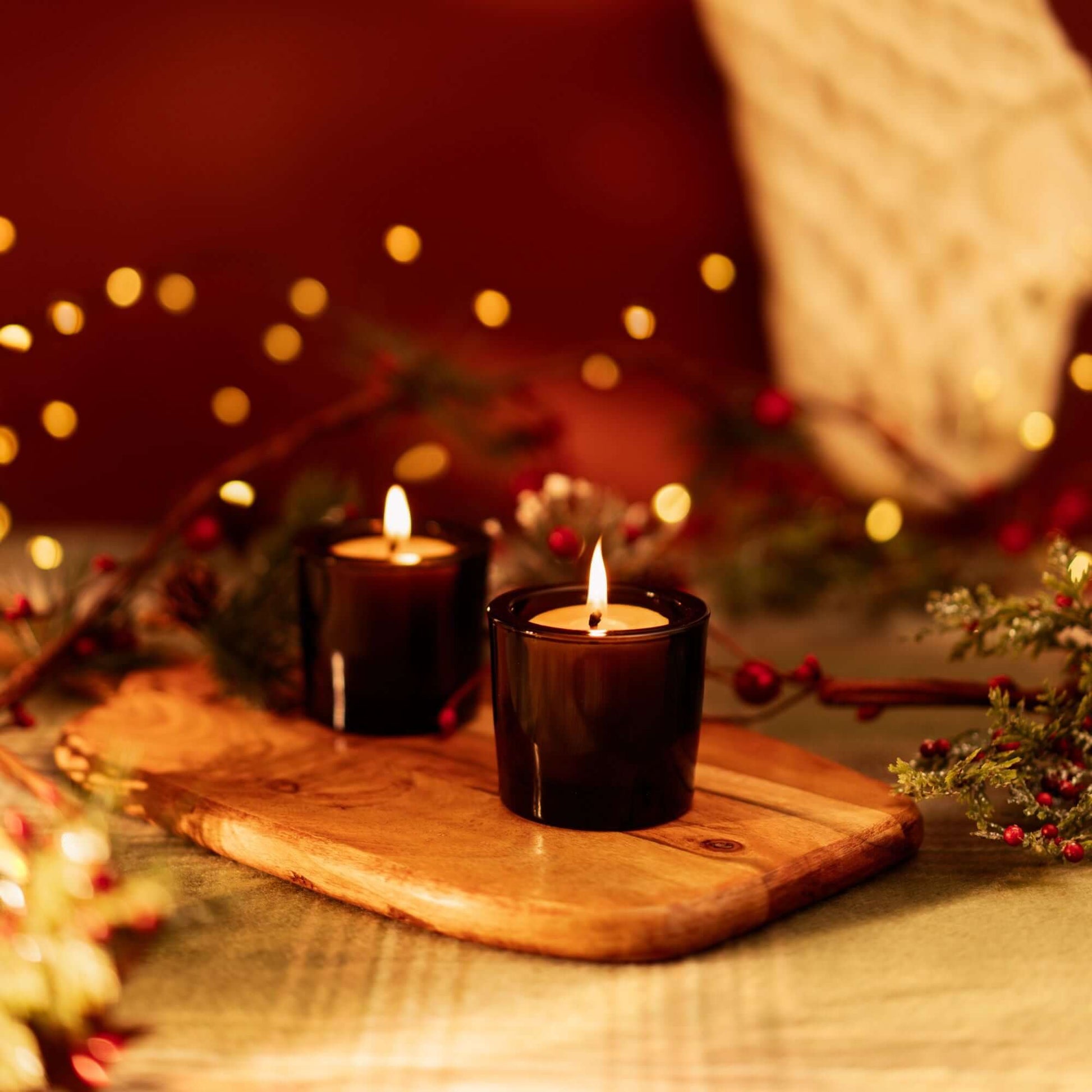 Bluecorn Candles pure beeswax votive candles, ideal for holiday decor and Christmas ambiance, showing warm glowing candles.