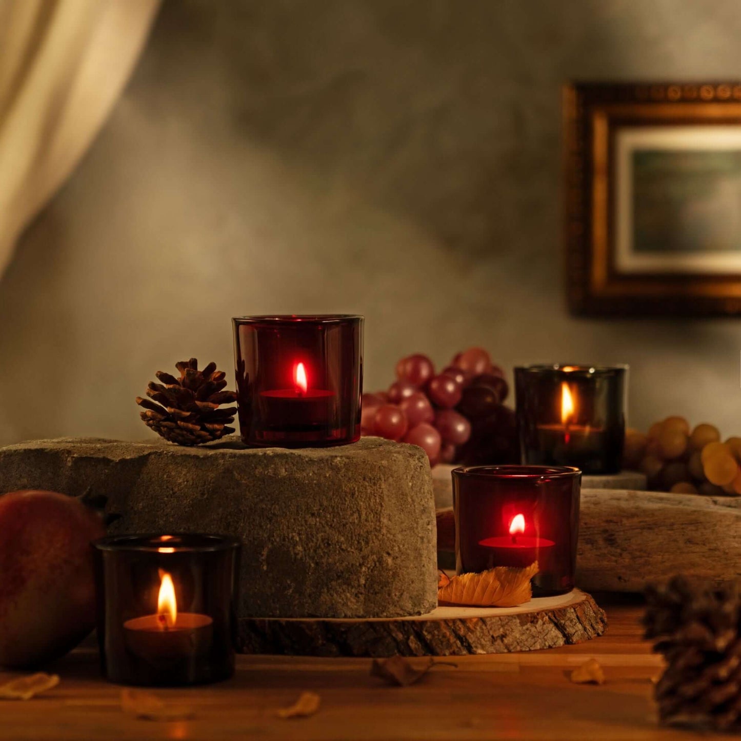 Set of Bluecorn Candles pure beeswax tea light candles in heavy glass votive holders with warm, natural candlelight.