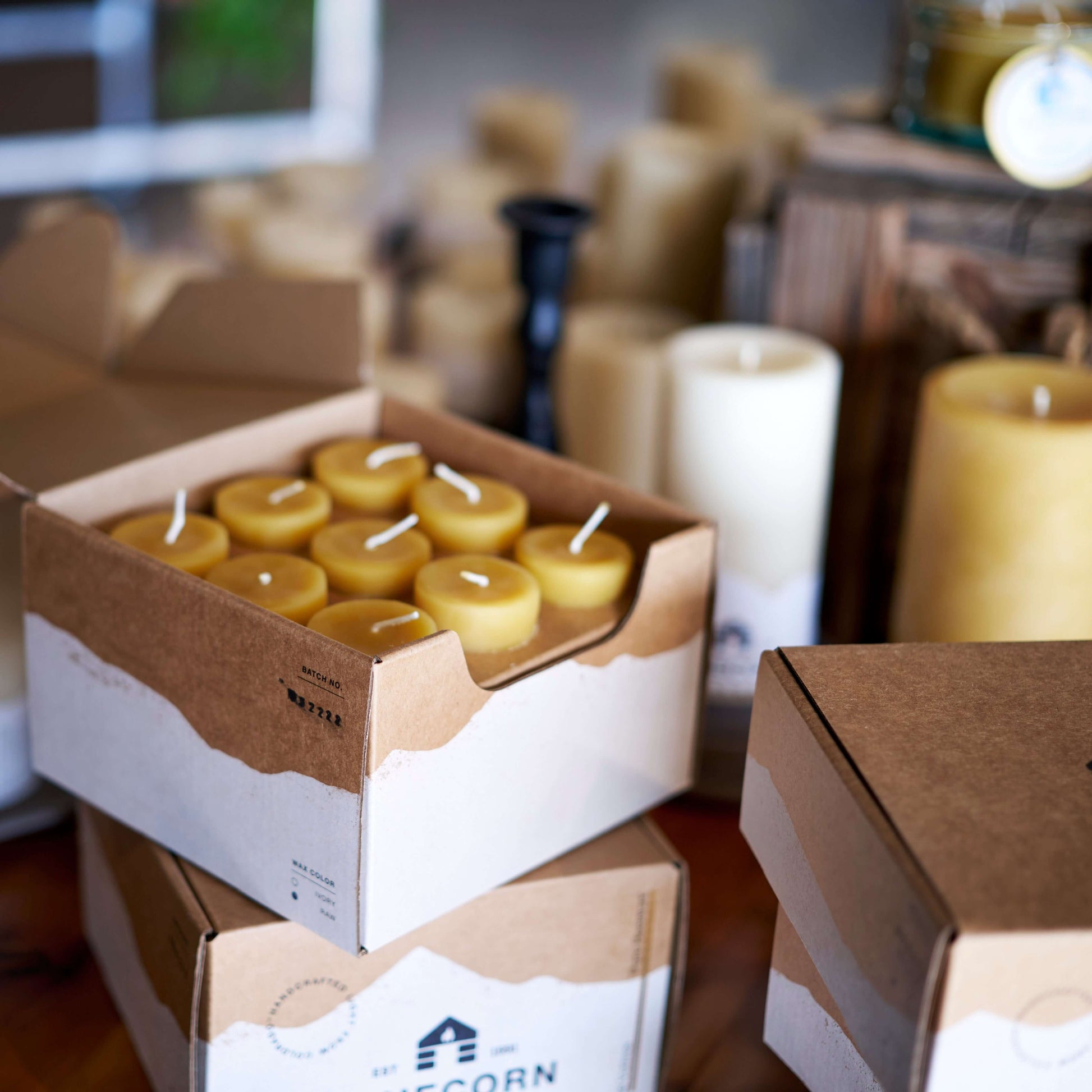 Set of Bluecorn Candles pure beeswax votive candles in sustainable packaging, showcasing soft glow and natural beeswax texture.