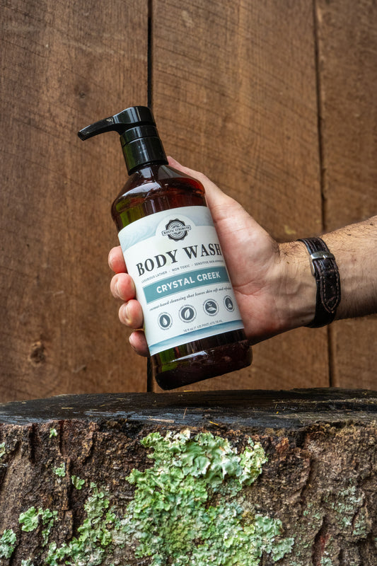 Rustic Strength Crystal Creek moisturizing body wash with natural ingredients, shown in a white bottle with a pump dispenser.
