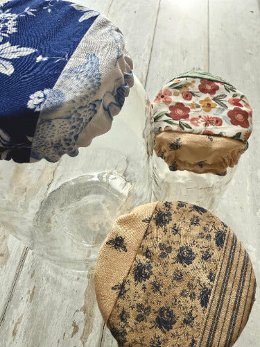 Farmhouse-style jar covers from Five Oaks Farm, featuring rustic designs perfect for preserving and decorating with mason jars.