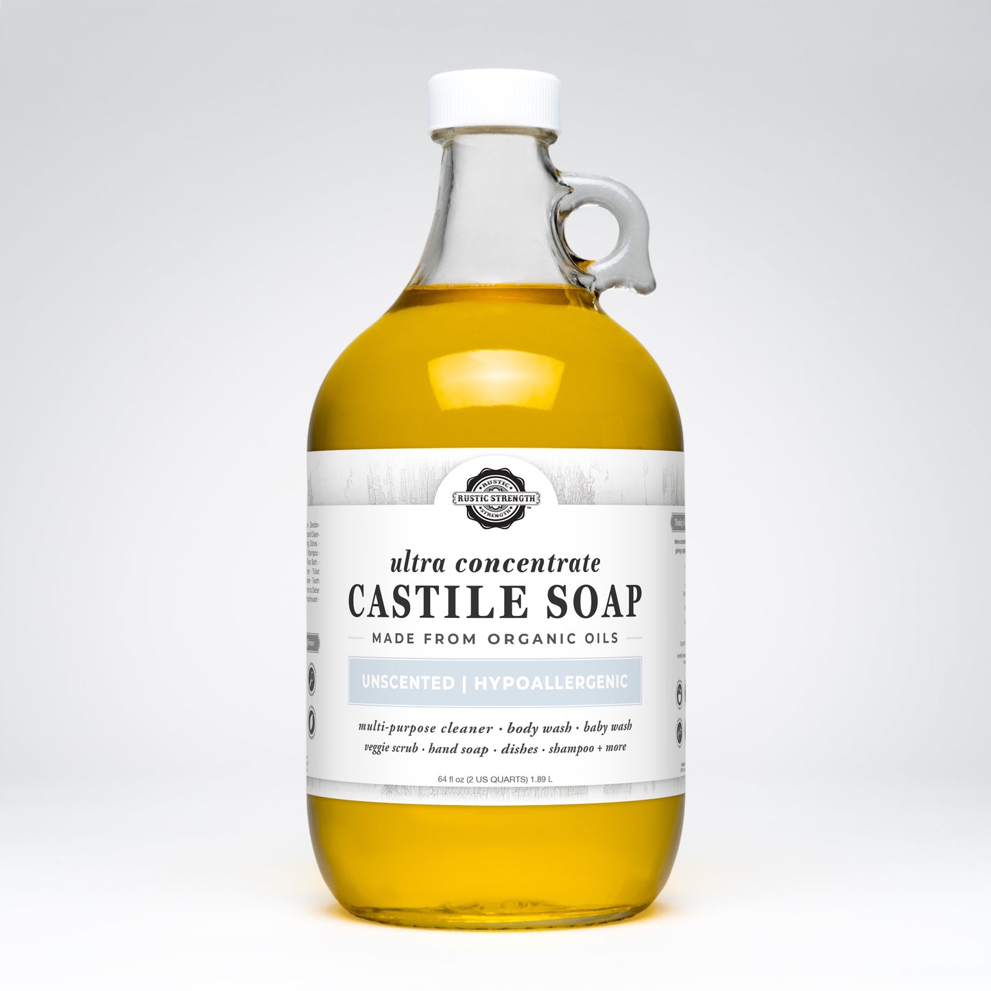 A clear glass bottle with a handle contains Rustic Strength’s Castile Soap - Ultra Concentrate | Unscented. The white label notes it’s a multi-purpose, hypoallergenic cleaner, made from organic oils and ultra-concentrated formula.