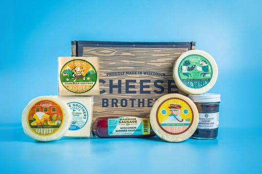 Assorted cheese, cured meats, and crackers in a charcuterie box from Cheese Brothers, Inc. for gifting or entertaining.