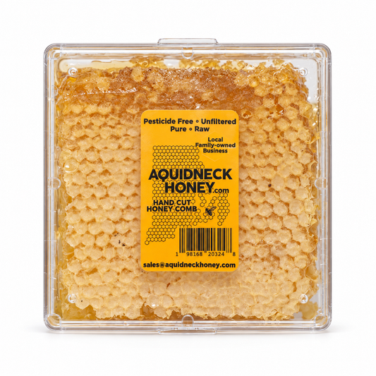 Hand-cut honey comb from New England by Aquidneck Honey, showcasing golden honey and natural beeswax in a close-up image.