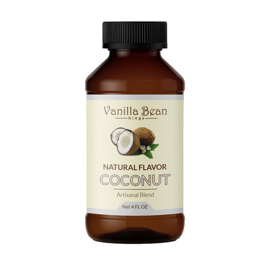 Natural coconut extract from Vanilla Bean Kings shown in a clear glass bottle with fresh coconuts in the background.