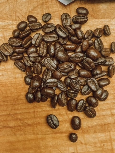 Onic Brands LLC Nicaraguan dark roast coffee beans, carbon negative, rich and aromatic, shown in a close-up image.