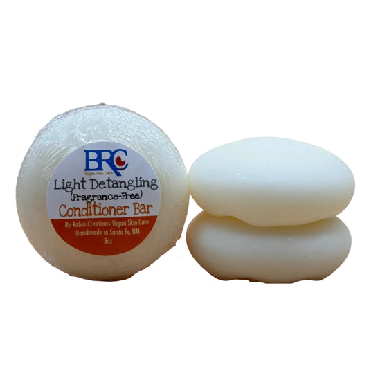 Light detangling natural hair conditioner bar by By Robin Creations, shown in a sleek, eco-friendly packaging.