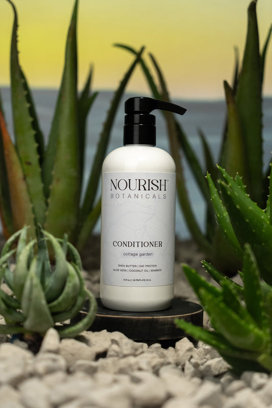 Rustic Strength Aloe Vera Conditioner from Cottage Garden, showing a sleek bottle of nourishing hair conditioner.