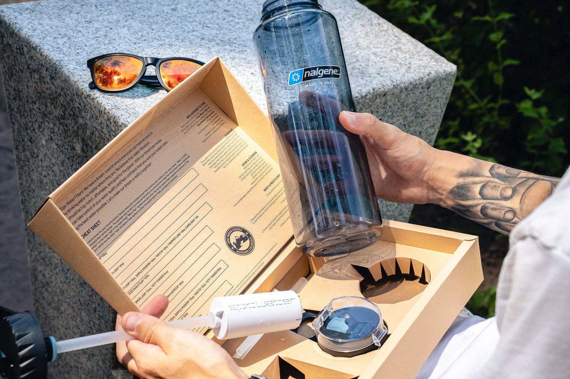 Epic Water Filters The Answer 2.0 water filter attachment for Hydro Flask and Nalgene bottles, black plastic with filter components visible.