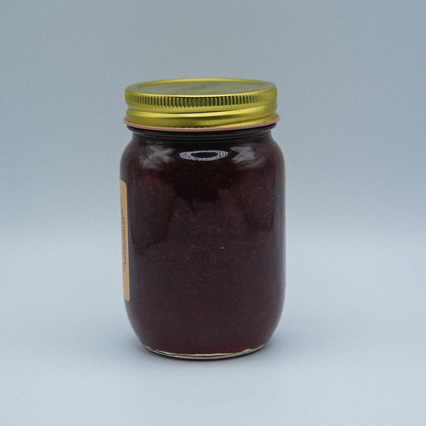 Canned Amish Country Store strawberry jam in an 18oz jar, with a bright red jam visible through the glass.