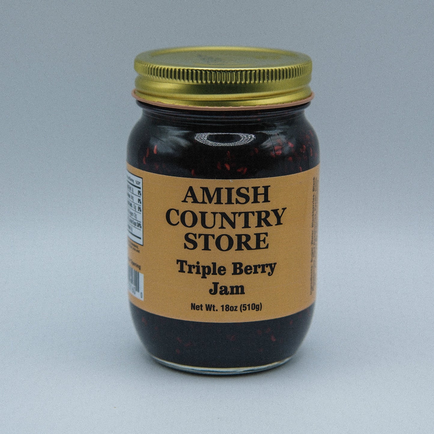 Amish Country Store triple berry jam in an 18oz jar, canned goods with fresh berry filling and fruit chunks.