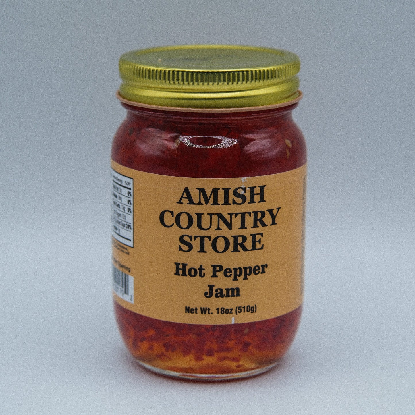 Amish Country Store hot pepper jam in 18oz canned jar, spicy red pepper spread with visible peppers and glossy texture.