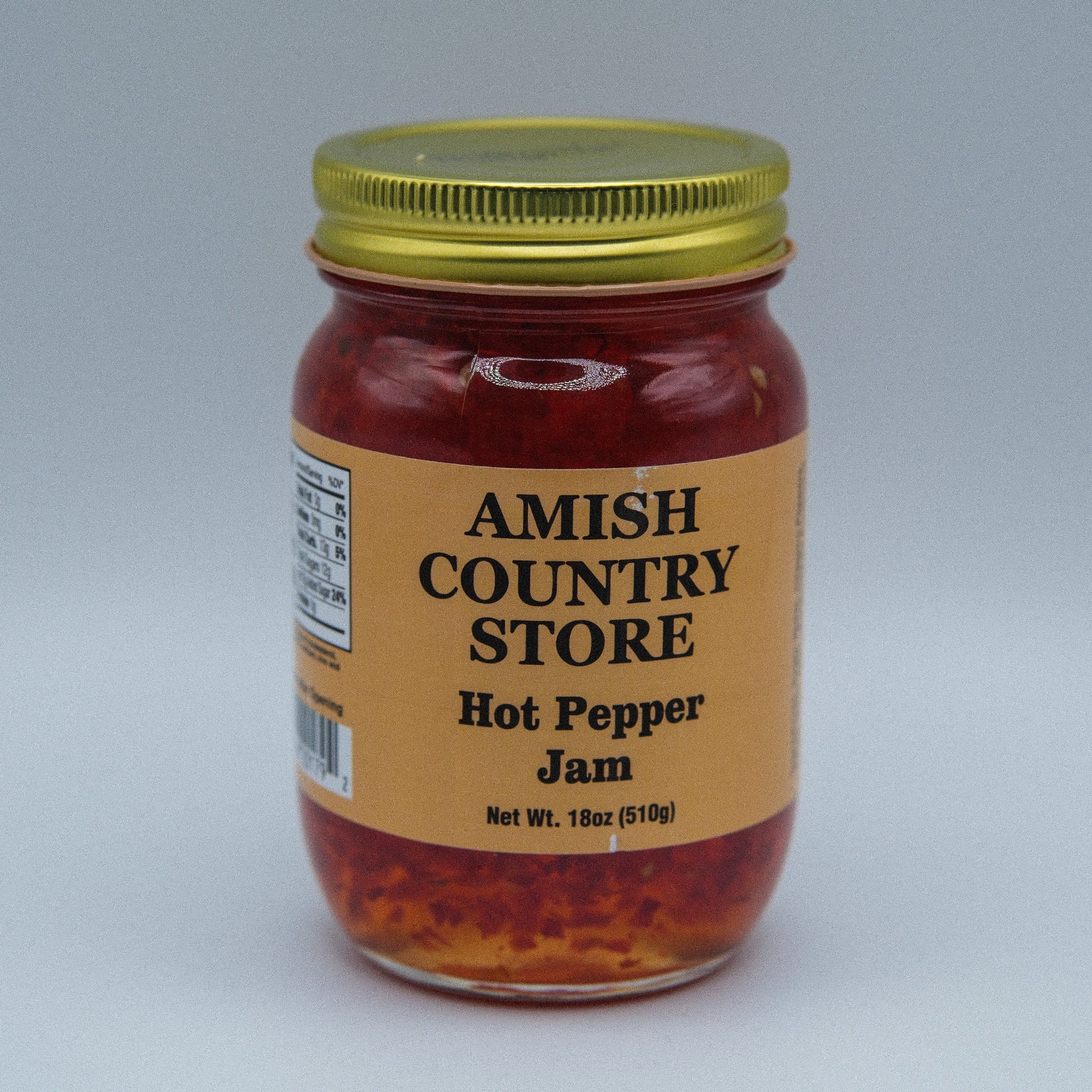 Amish Country Store hot pepper jam in 18oz canned jar, spicy red pepper spread with visible peppers and glossy texture.