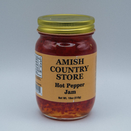 Amish Country Store hot pepper jam in 18oz canned jar, spicy red pepper spread with visible peppers and glossy texture.