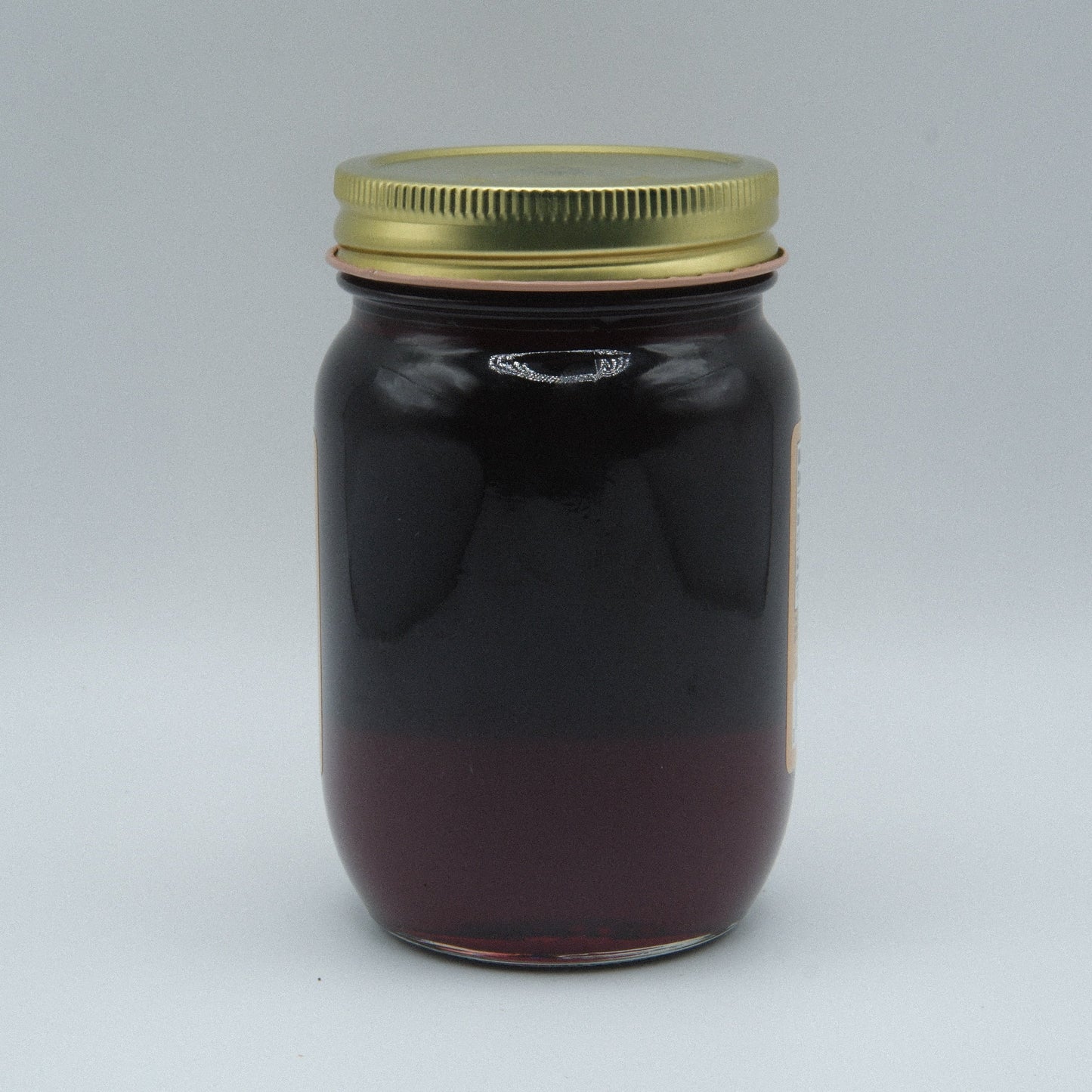 Canned Amish Country Store Concord Grape Jelly in an 18 oz jar, showcasing the jar with purple grape jelly inside.