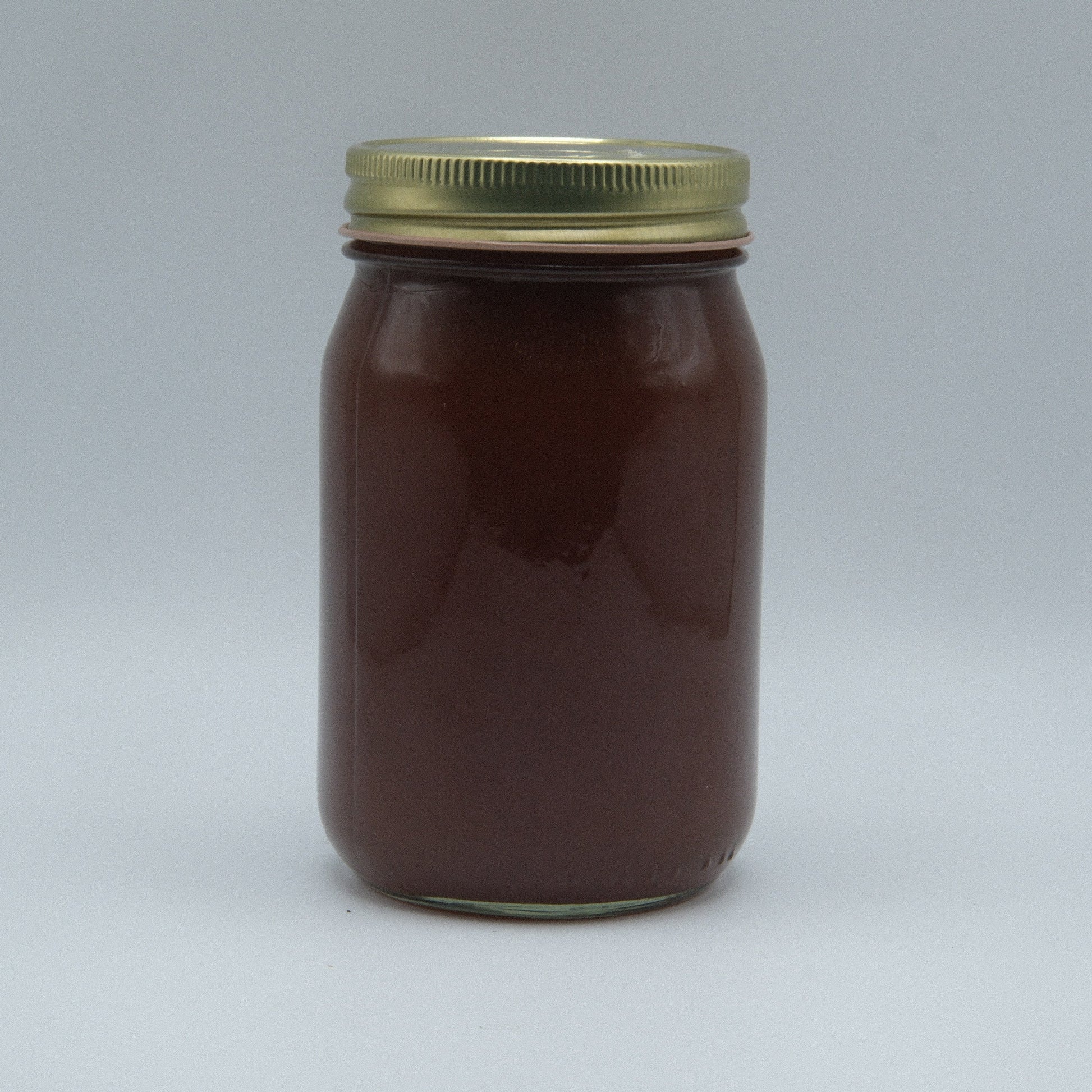 Amish Country Store Miller's apple butter Amish jam jar with label and apple butter spread visible.