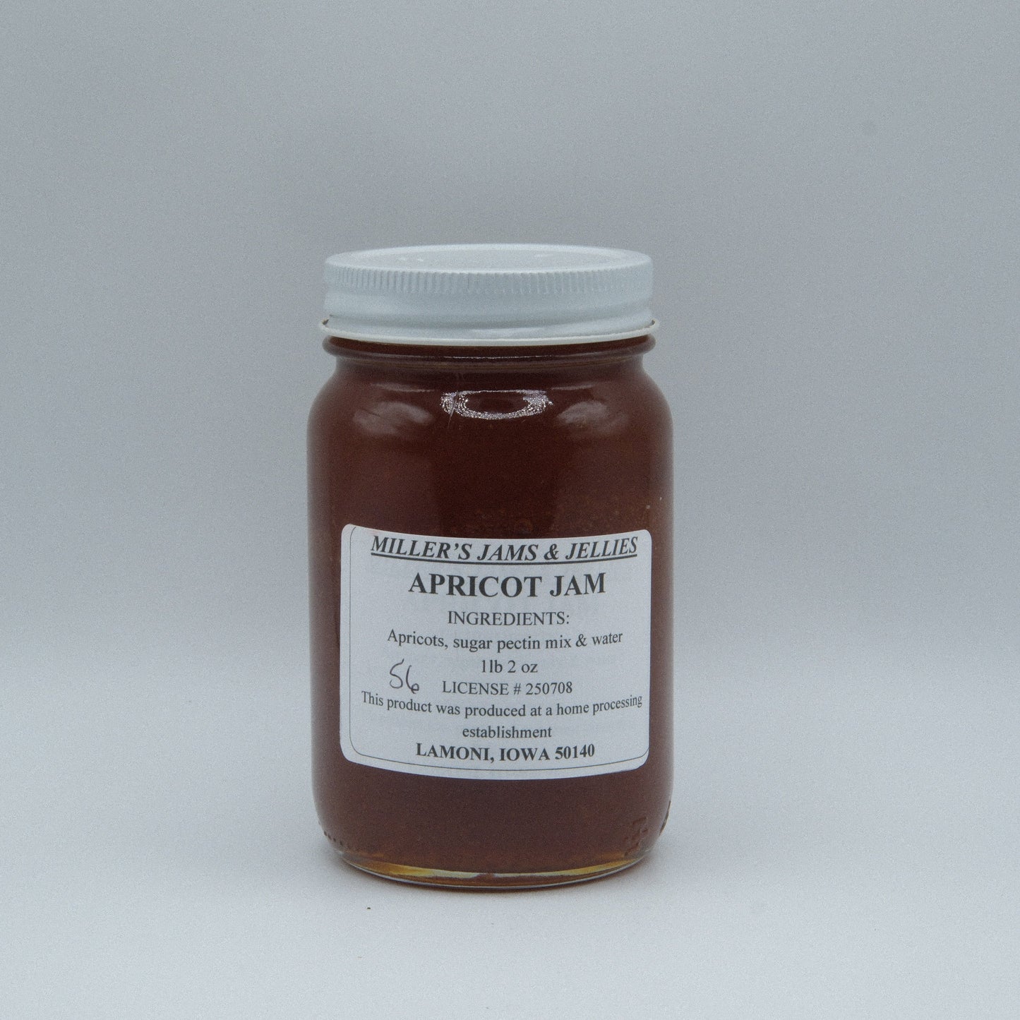 Amish Country Store Miller’s Apricot Jam jar with apricot pieces and jam spread, close-up of the Amish-made fruit preserve