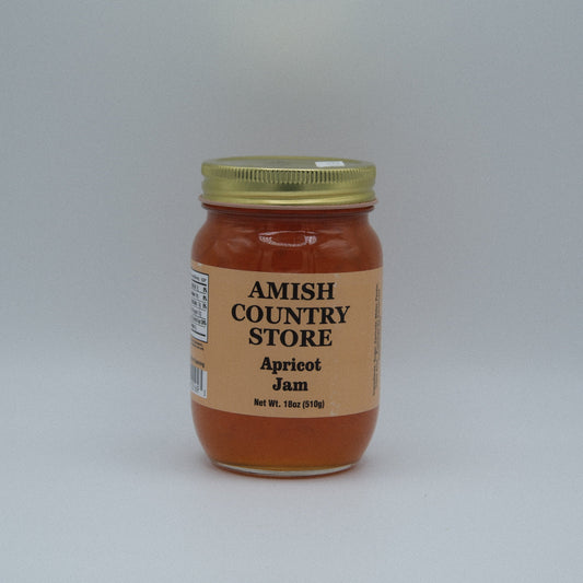 Canned apricot jam in a jar from Amish Country Store, showing fresh apricots and the jam's orange color.