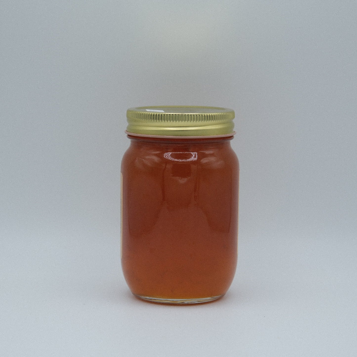 Canned apricot jam in an 18 oz jar from Amish Country Store, showing the golden-orange jam inside a glass jar.