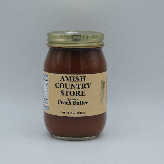 Canned peach butter in a 16oz jar from Amish Country Store, showing smooth, peach-colored spread with a lid.