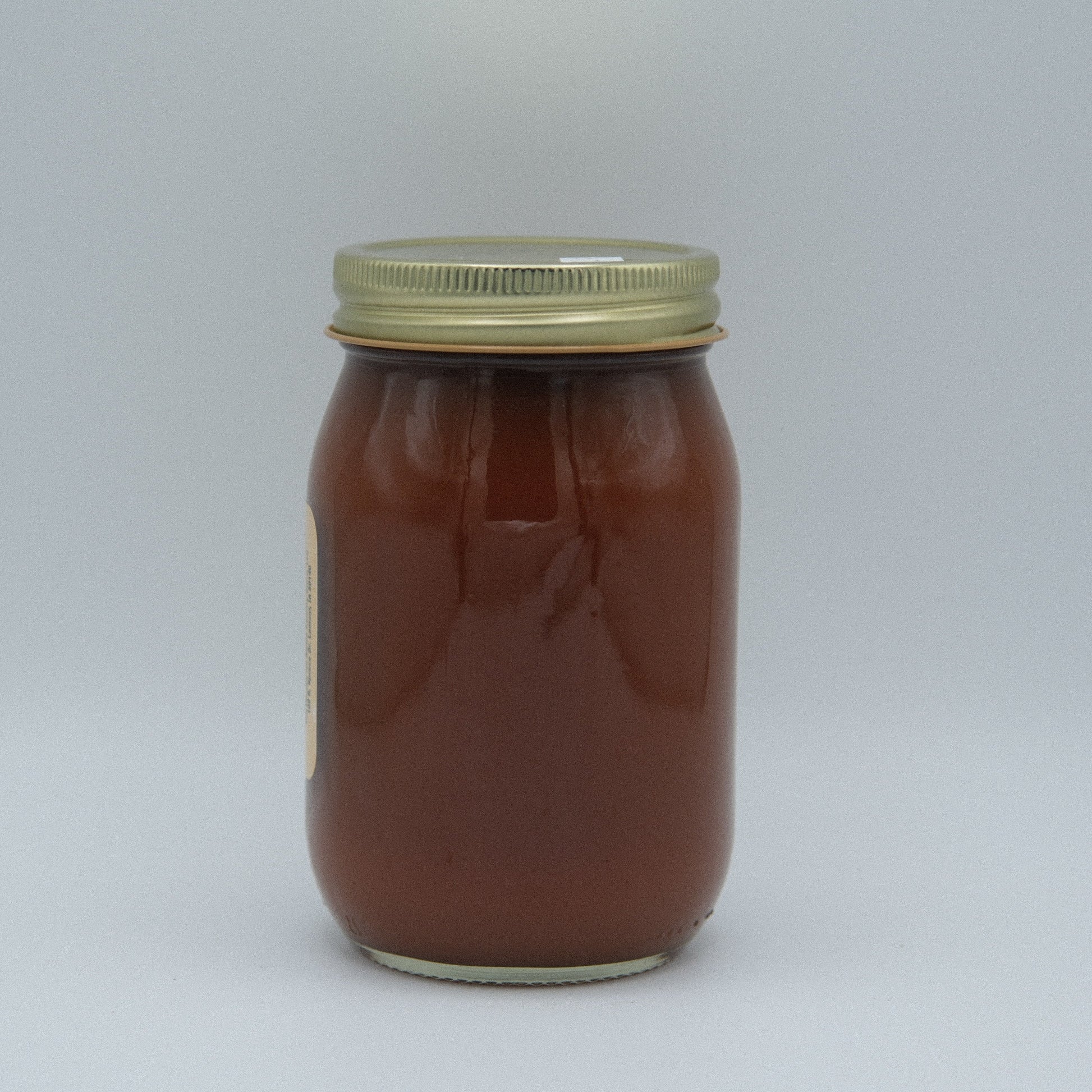 Canned Amish Country Store Peach Butter jar with label, showing smooth, golden peach spread inside a 16oz container.